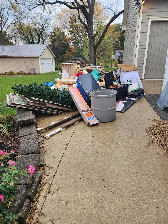 Dumpster being loaded with debris for Roofing Dumpster Rental in Twin Falls